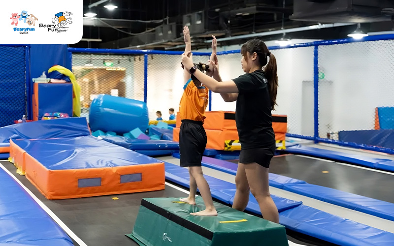 Child learning gymnastics in a controlled environment