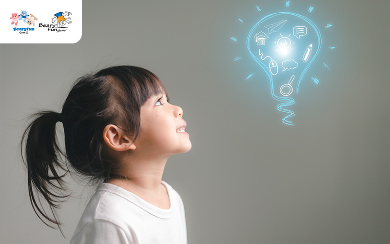 Child looking at a lightbulb idea illustration.