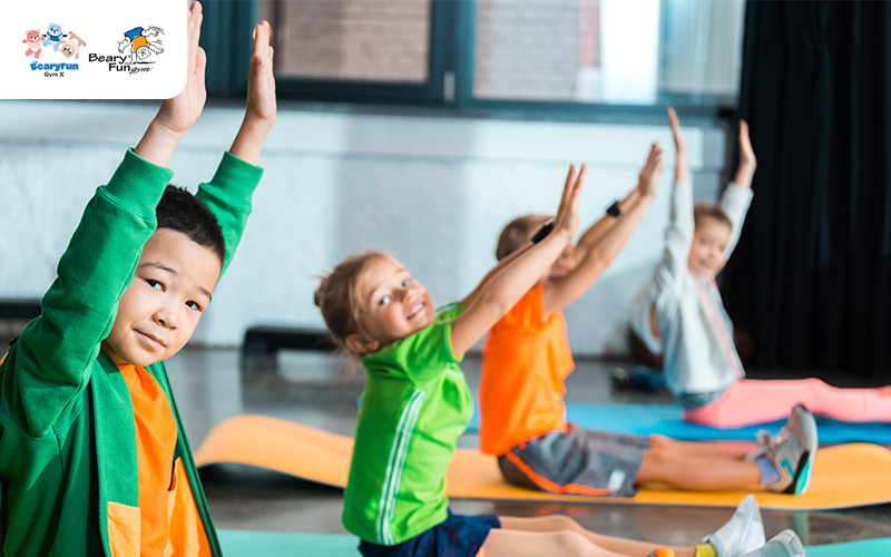 Children stretching and exercising in a gymnastics class.