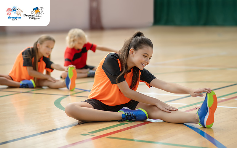 Children stretching before their first gymnastics class.