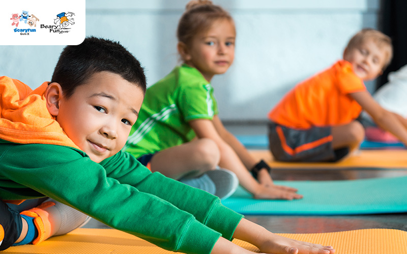 Children stretching on mats, enhancing gross motor skills.
