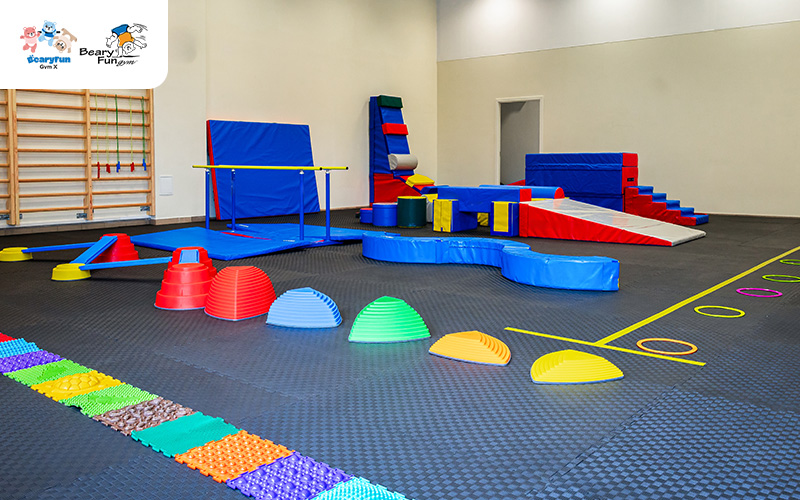 Gym with equipment for children's motor skills development.