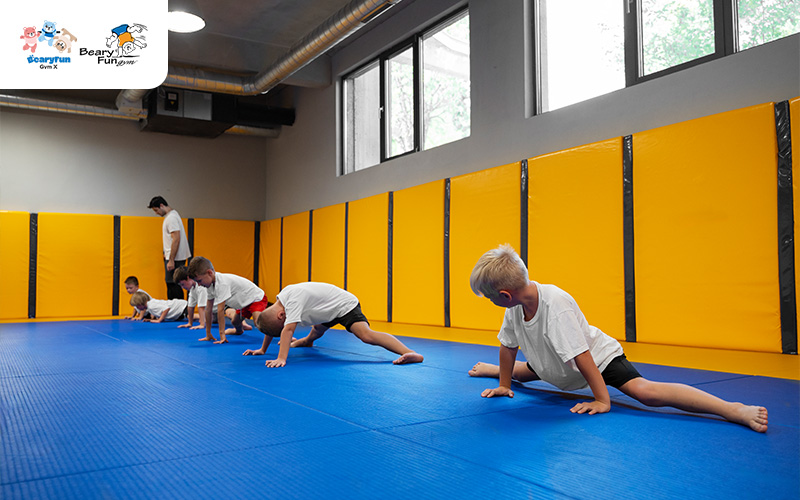 Young children stretching in gymnastics class