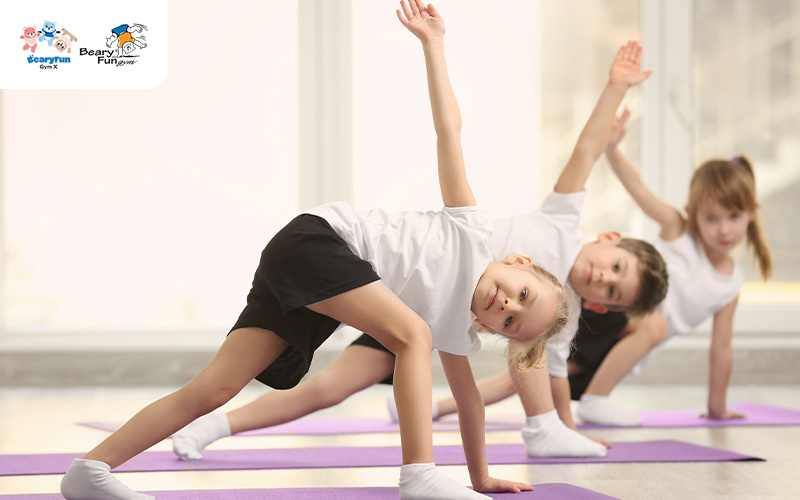 Kids practicing static stretching at BearyFunGym to prevent injuries.