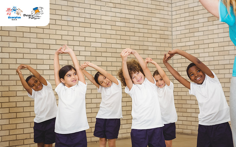 Group of children doing side-stretches at BearyFunGym.
