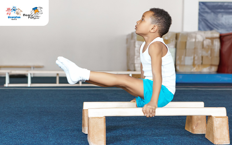 Child performing gymnastics on parallel bars.