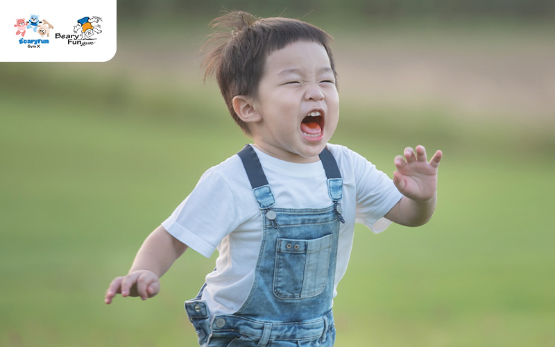 3-year-old child running excitedly in a field.