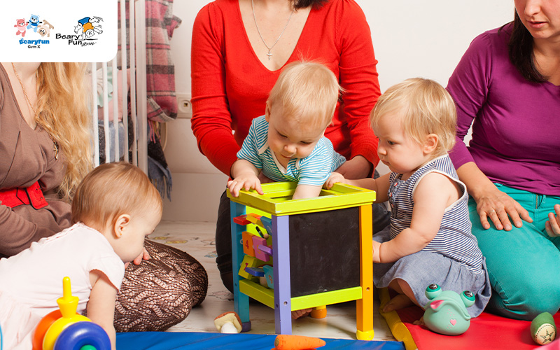 Babies playing with a toy with supervision.