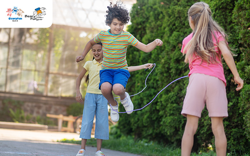 Children jumping rope outdoors.