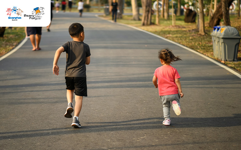 Children running outdoors, fostering physical development.