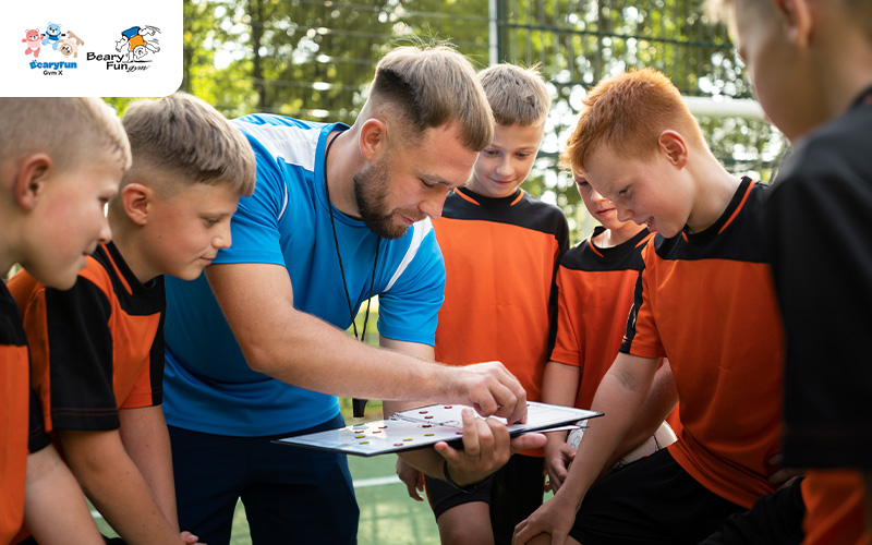 Coach explaining soccer strategy to young players.