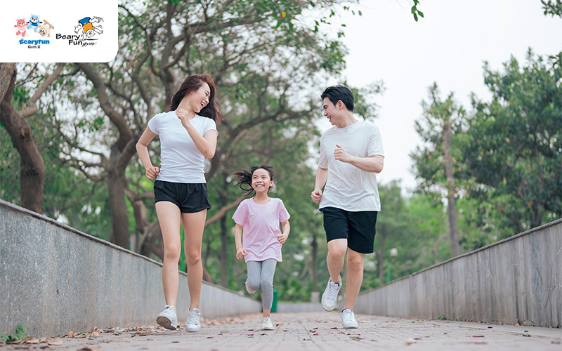 Family jogging together outdoors, enjoying healthy exercise.