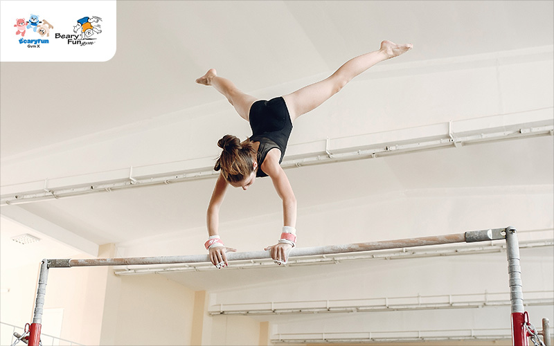 Girl on gymnastics bars demonstrating physical strength.