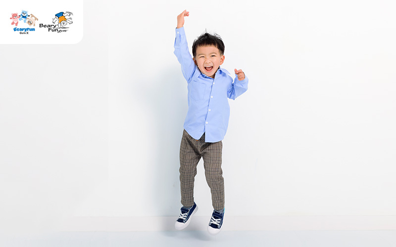 Happy toddler jumping, showing physical development milestone.