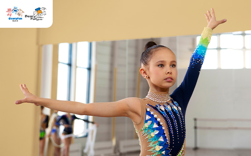 Rhythmic gymnast performing a routine in the studio.