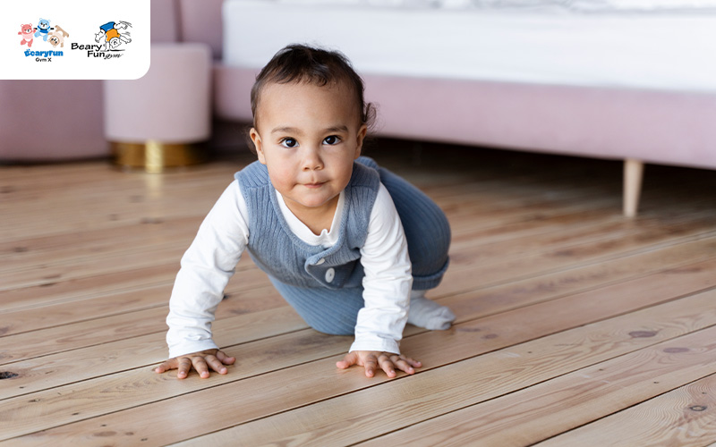 Toddler crawling on the floor to develop physical skills.