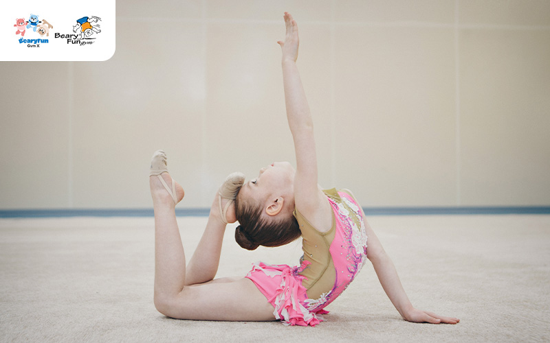 Young girl doing a gymnastics pose.