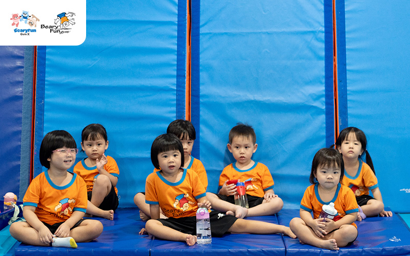 Young preschoolers resting on mats in the Beary Fun Gym.